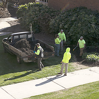 Grounds crew planting flowers