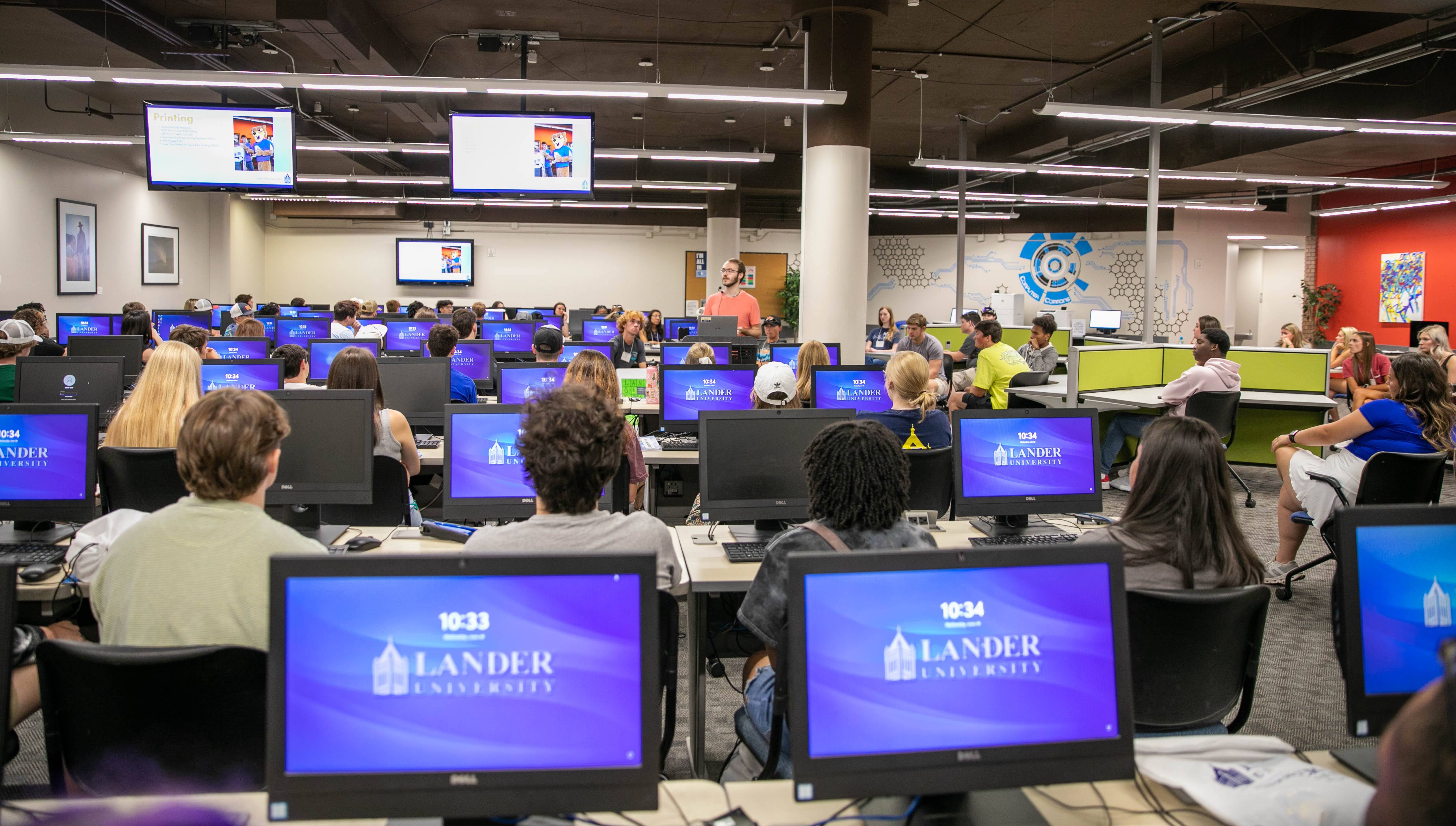 student in plaza with laptop